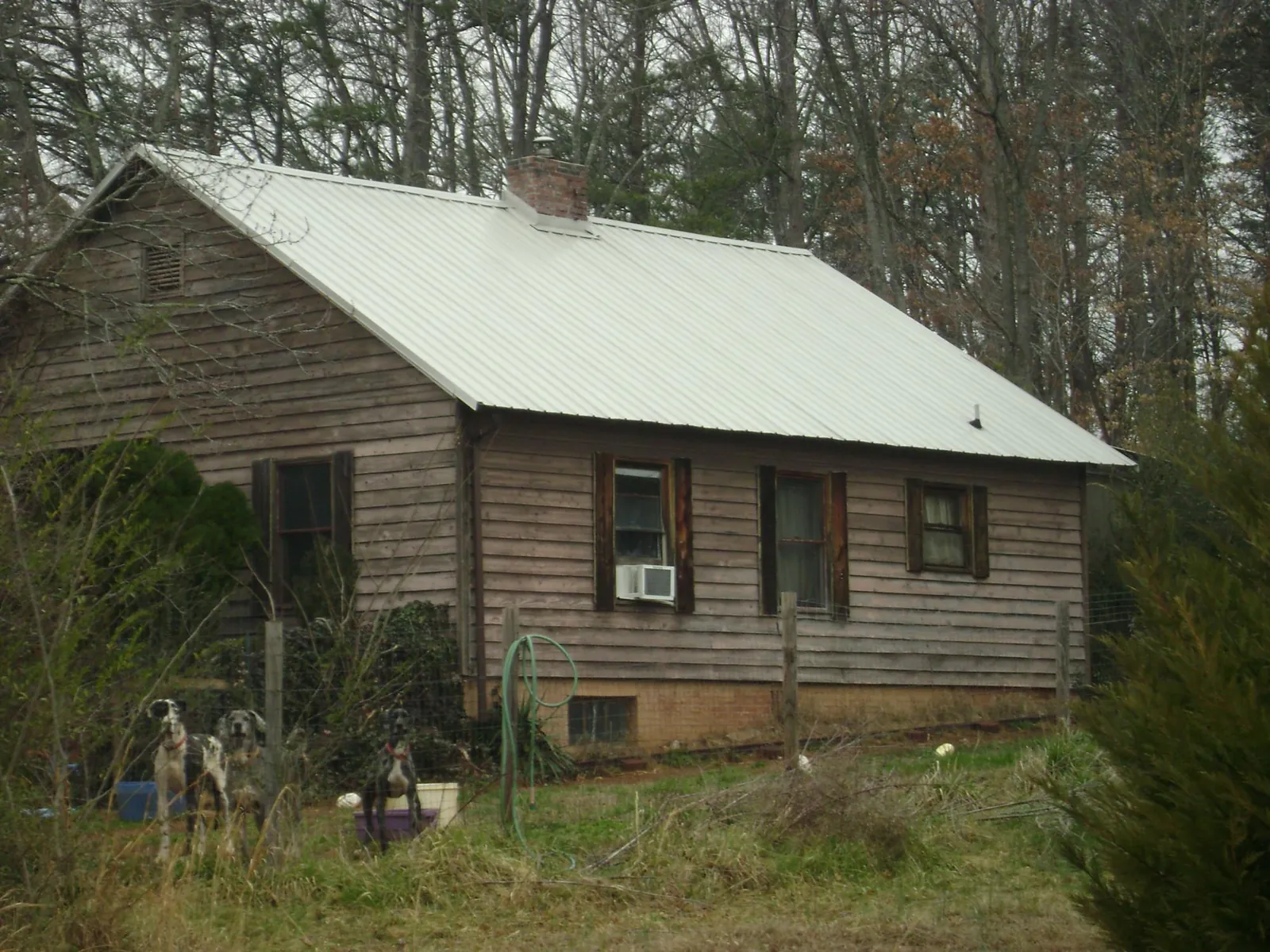 White metal roof on an old wood sided farmhouse, from a Metal Roof Installation job in Sanbornton